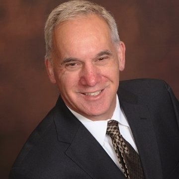 Headshot of David Stensland, founder of Ark +Energy, dressed in suit and tie.